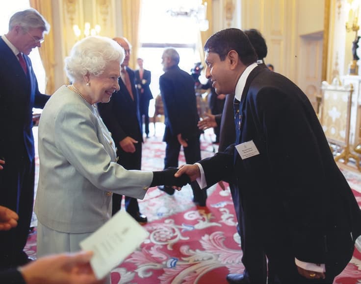 A rare and memorable honour: Her Majesty Queen Elizabeth II greeting Milinda at Buckingham Palace while attending the Association of Commonwealth Universities Congress in October 2013.
