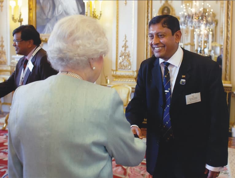 A rare and memorable honour: Her Majesty Queen Elizabeth II greeting Milinda at Buckingham Palace while attending the Association of Commonwealth Universities Congress in October 2013.