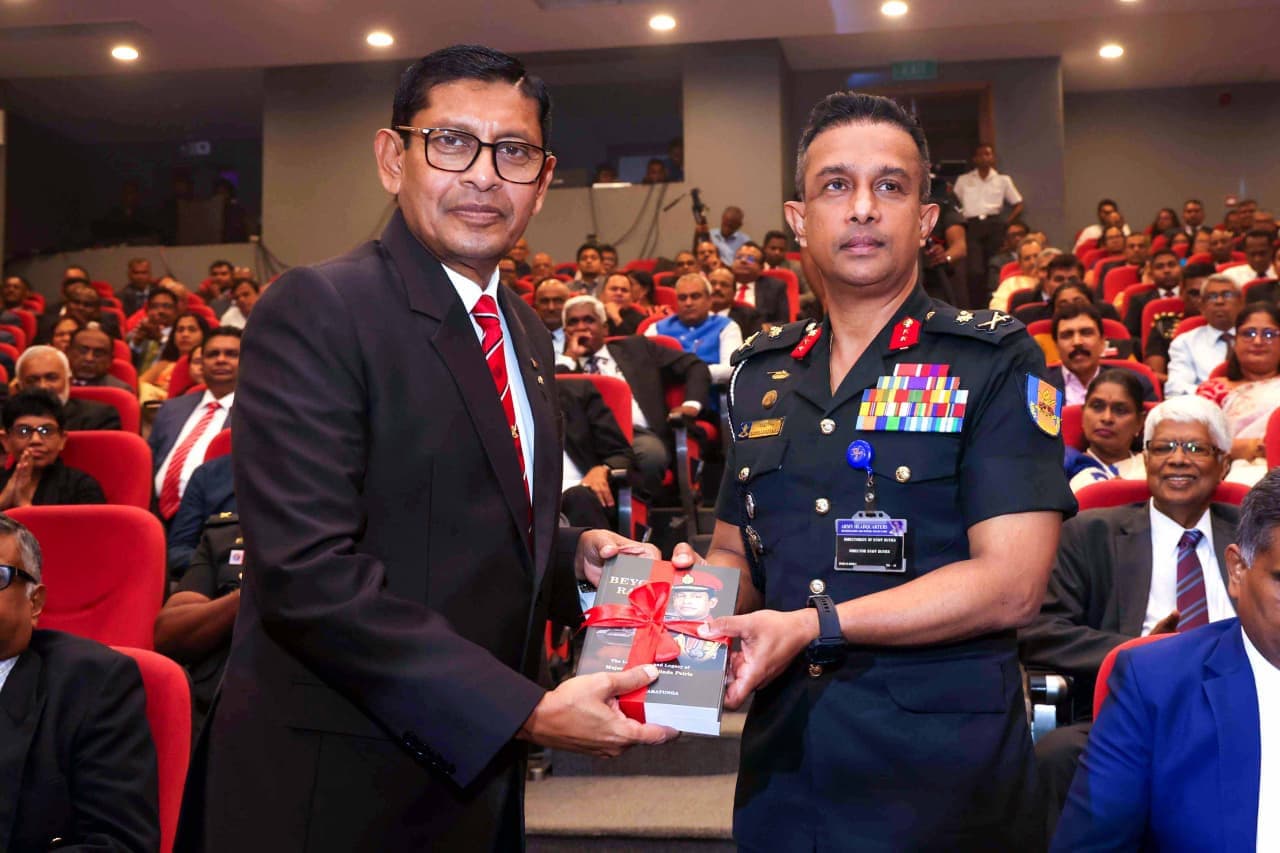 Major General (Retd) Milinda Peiris presenting a copy of Beyond Rank to Air Vice Marshal P. N. de Costa, Deputy Chief of Staff of the Sri Lanka Air Force.